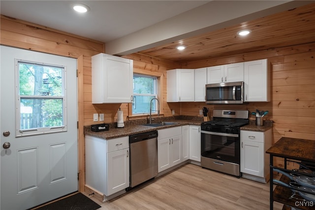 kitchen featuring appliances with stainless steel finishes, plenty of natural light, sink, and white cabinets