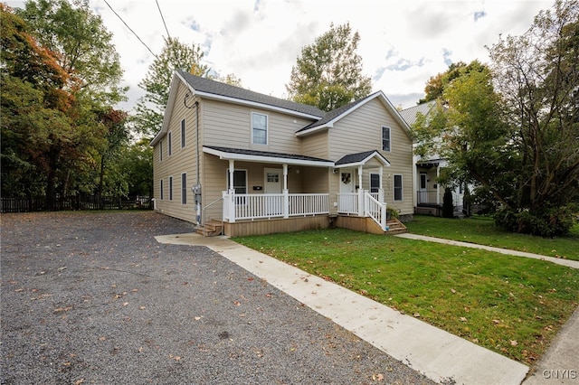 view of front of property featuring covered porch and a front yard