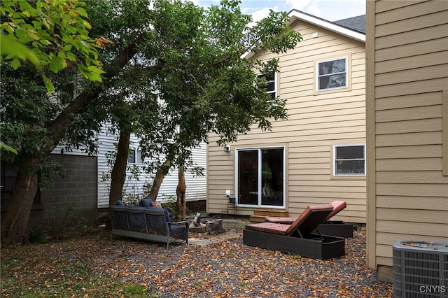 rear view of property featuring central air condition unit and a patio area