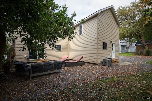 back of property featuring cooling unit and a patio area