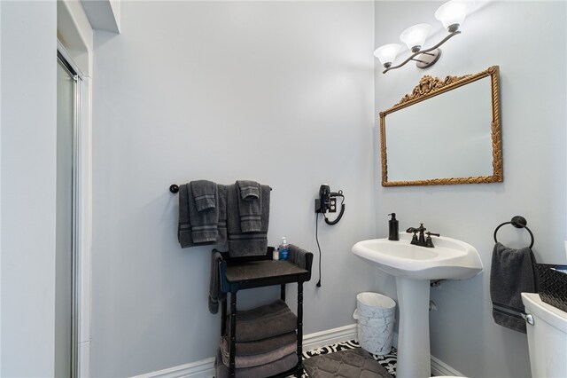 bathroom featuring walk in shower and toilet