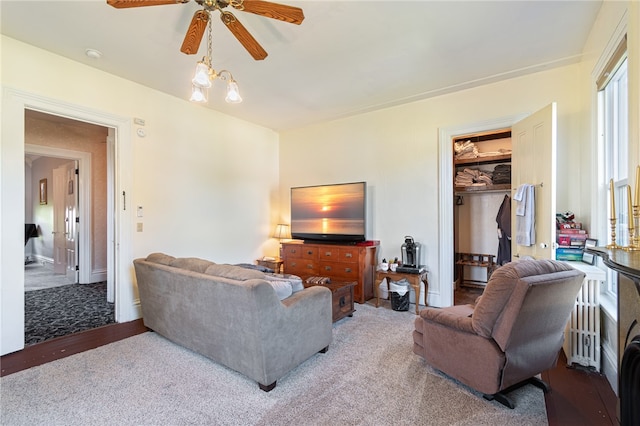 living room featuring ceiling fan and carpet