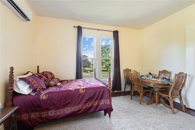 bedroom featuring carpet floors and a wall mounted air conditioner