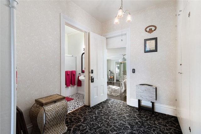 hallway featuring wallpapered walls, carpet floors, and baseboards