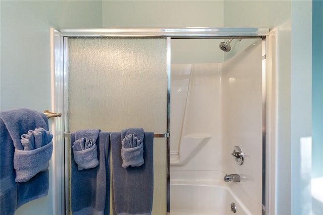 full bath featuring combined bath / shower with glass door
