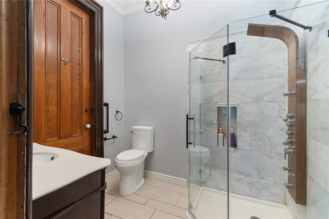 bathroom with tile patterned flooring, a notable chandelier, walk in shower, vanity, and toilet