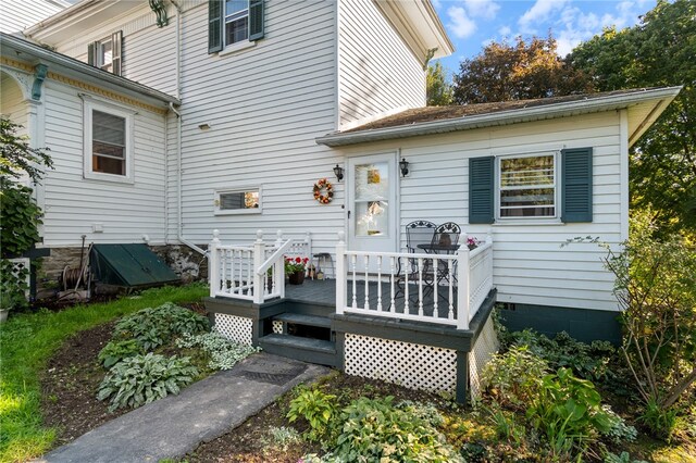 rear view of property with a wooden deck