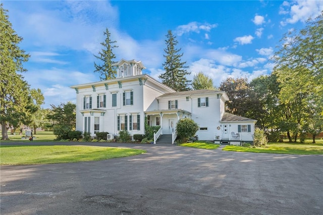 italianate-style house with driveway and a front lawn