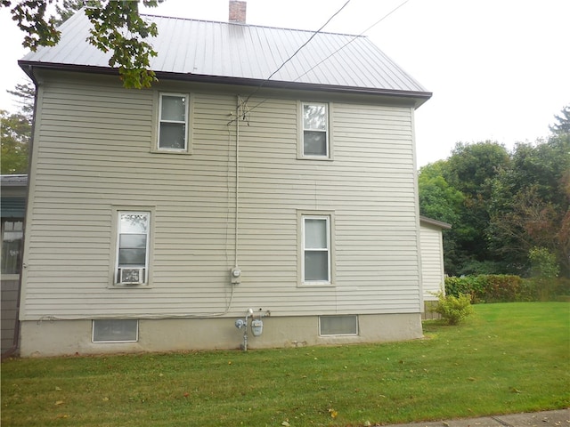 view of side of property with a lawn