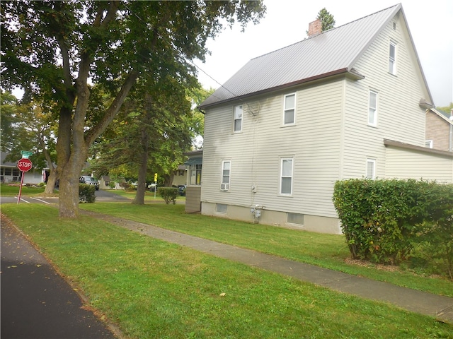 view of side of property with a yard