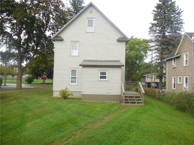 rear view of property featuring a yard