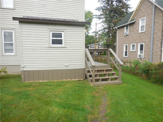 back of property featuring cooling unit and a yard