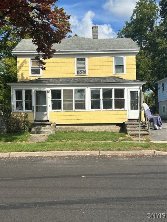 view of front of home with a sunroom