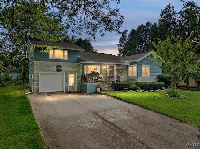 tri-level home with a yard and a garage