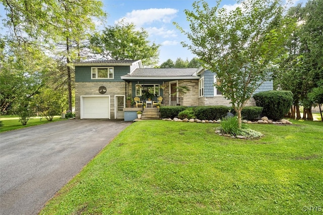 split level home featuring a front yard and a garage