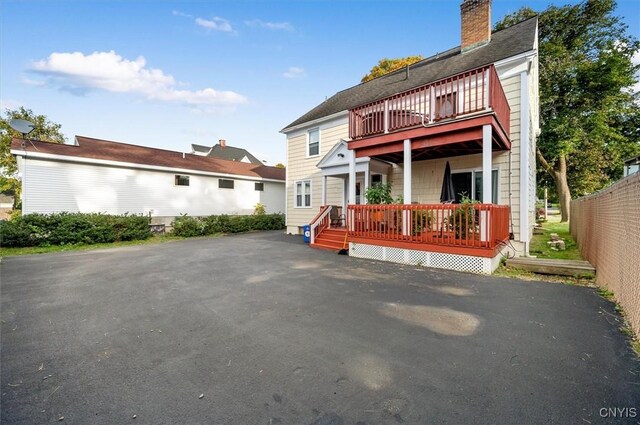 back of property with a wooden deck