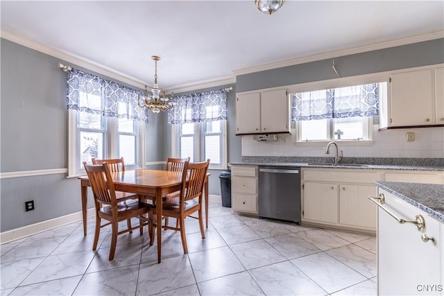 dining area with a notable chandelier, sink, and ornamental molding