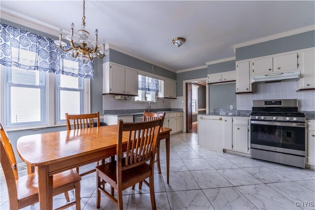 kitchen featuring backsplash, stainless steel gas range oven, sink, crown molding, and white cabinets