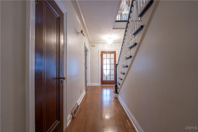 hallway with crown molding and hardwood / wood-style flooring