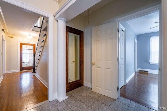 hall featuring ornate columns and a wealth of natural light