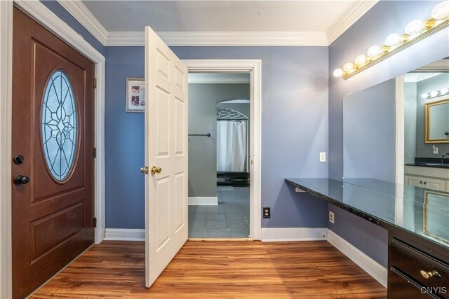 foyer featuring crown molding and hardwood / wood-style floors