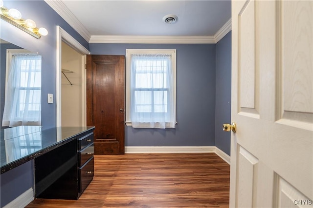 interior space with dark hardwood / wood-style flooring, crown molding, and a healthy amount of sunlight