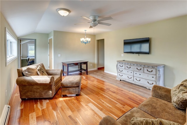 living room with ceiling fan with notable chandelier, baseboard heating, light wood-type flooring, and vaulted ceiling