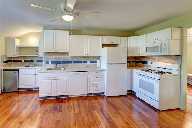 kitchen with sink, light hardwood / wood-style floors, white appliances, and white cabinetry