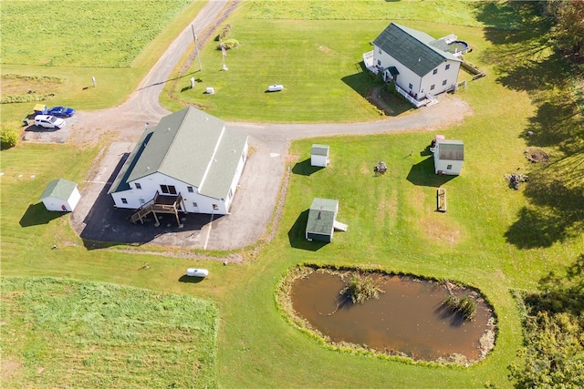 birds eye view of property with a water view and a rural view