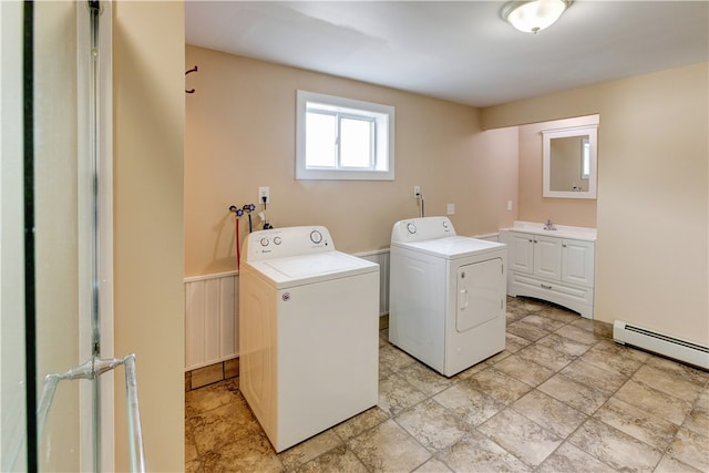 washroom featuring cabinets, baseboard heating, and washer and dryer