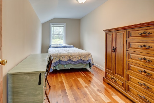 bedroom with light hardwood / wood-style floors and vaulted ceiling