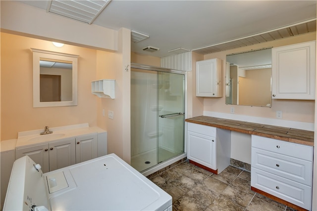 bathroom with vanity and a shower with shower door