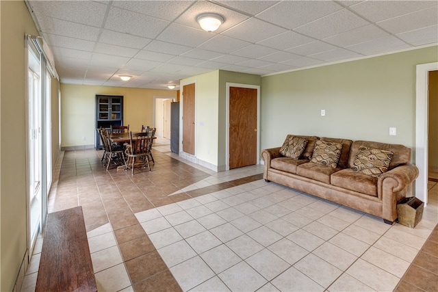 tiled living room featuring a drop ceiling