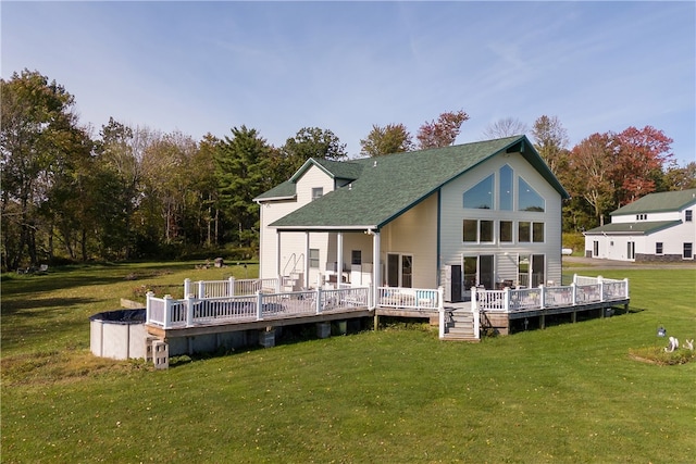 rear view of property with a lawn and a deck