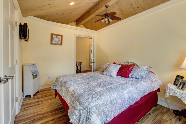 bedroom featuring ornamental molding, vaulted ceiling with beams, ceiling fan, and hardwood / wood-style floors