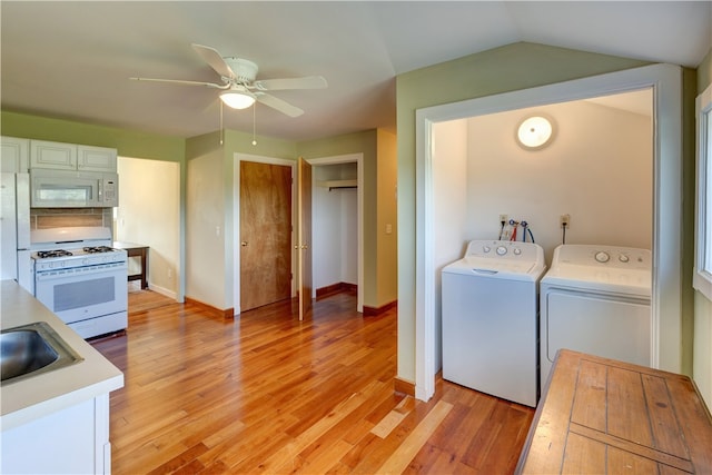 washroom featuring ceiling fan, separate washer and dryer, light hardwood / wood-style flooring, and sink