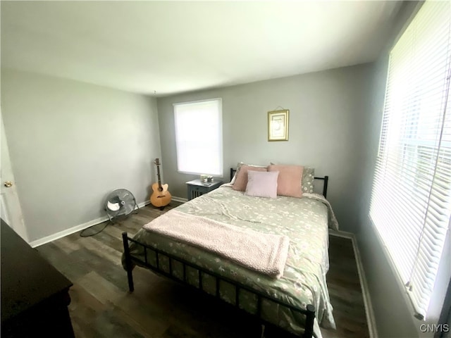 bedroom with dark hardwood / wood-style flooring