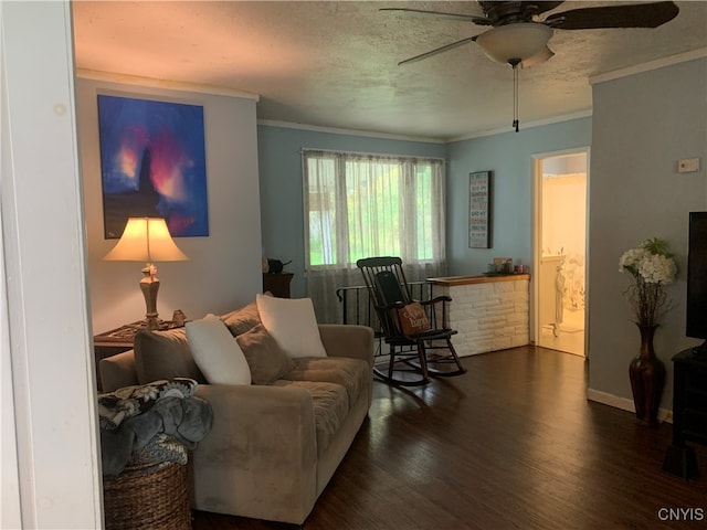 living room featuring ornamental molding, ceiling fan, dark hardwood / wood-style floors, and a textured ceiling