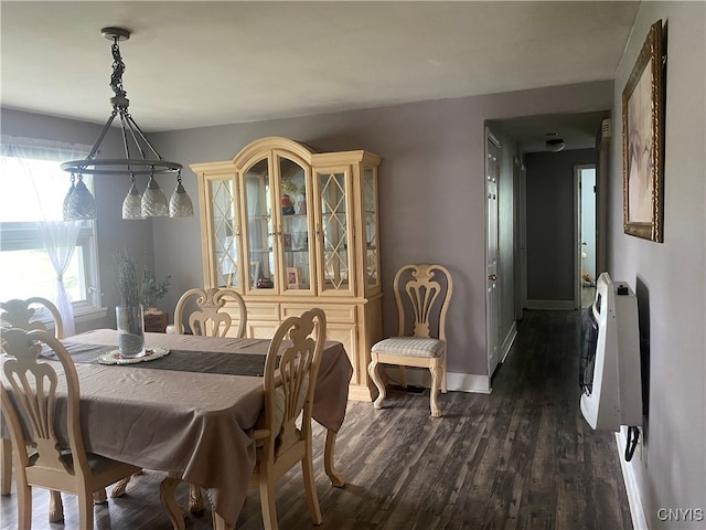 dining area with dark hardwood / wood-style flooring and heating unit