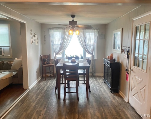 dining space with ceiling fan and dark wood-type flooring