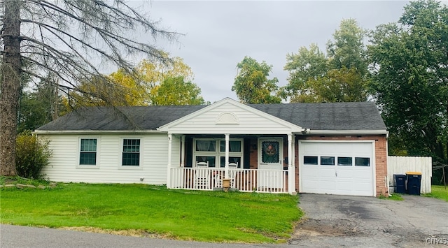 ranch-style house with a front yard, a garage, and a porch