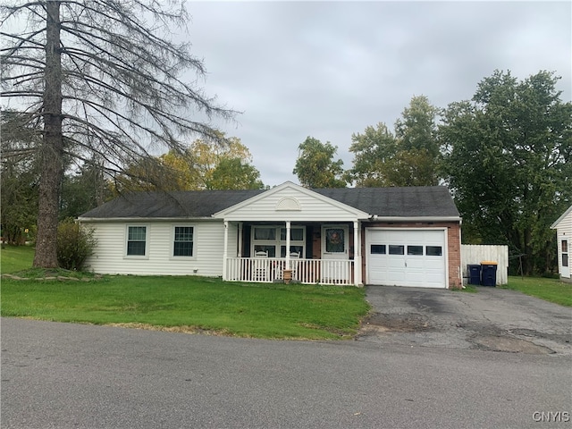 single story home with a porch, a garage, and a front yard