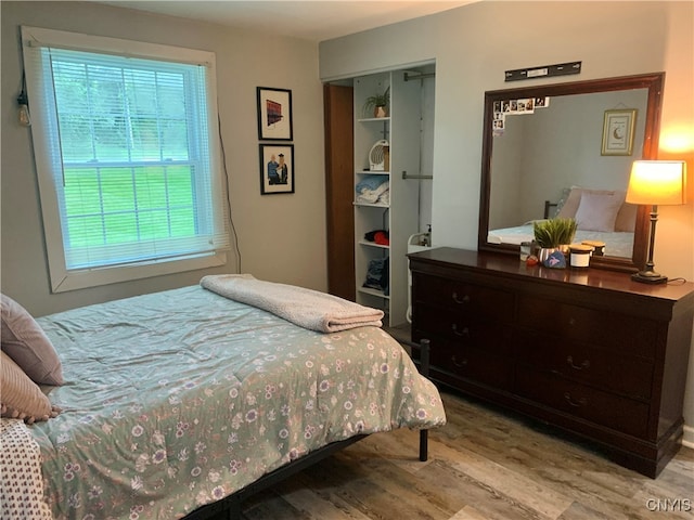 bedroom featuring light hardwood / wood-style floors and a closet