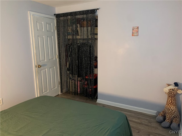 bedroom featuring a closet and dark hardwood / wood-style flooring