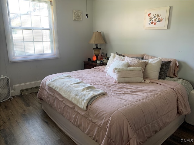 bedroom with dark hardwood / wood-style floors