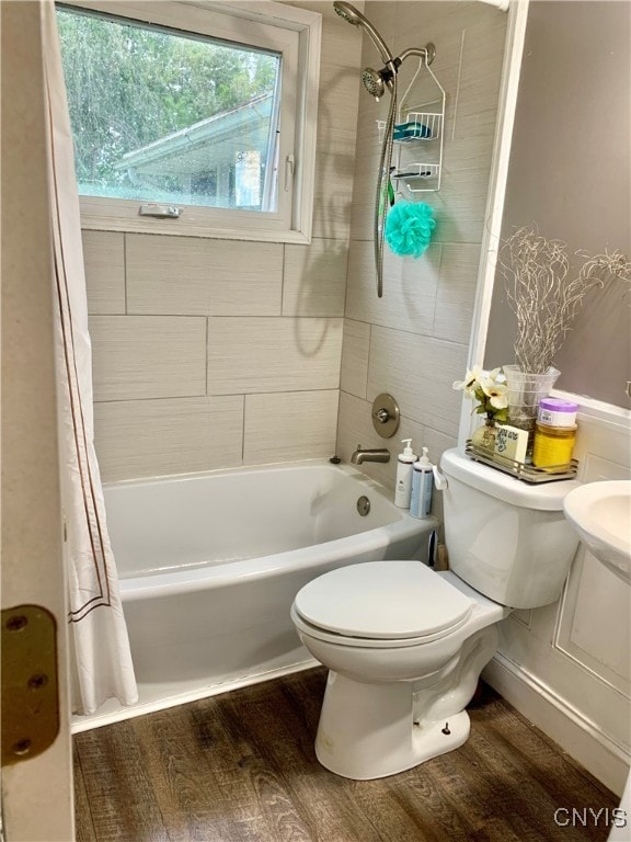 bathroom with wood-type flooring, toilet, and shower / tub combo