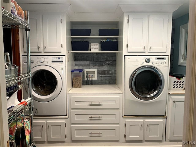 laundry room with cabinets and washer / dryer