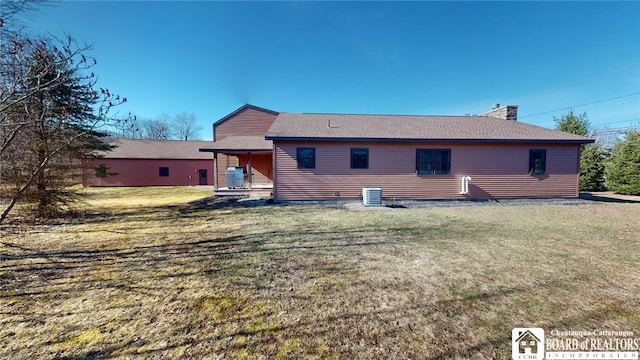 rear view of house featuring cooling unit, a yard, and a patio area