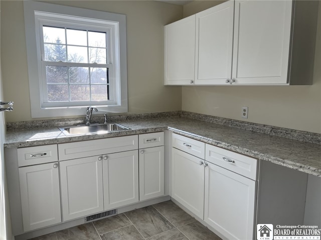 kitchen with white cabinets and sink