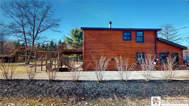 view of property exterior featuring a wooden deck